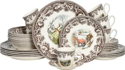 A collection of dinnerware, including plates, bowls, and cups, with a nature-themed design.