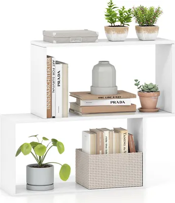 A white, multi-level bookshelf with decorative items and books.