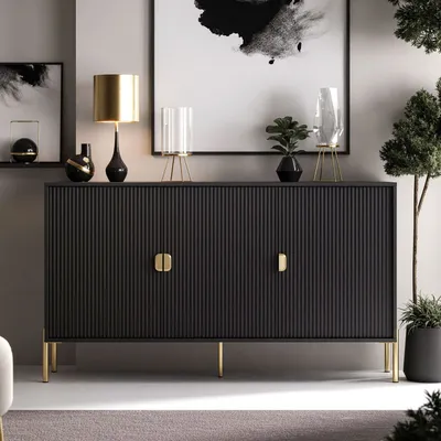 A modern living room setting with a black sideboard, decorative items, and a plant.