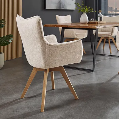 A dining chair is shown in a modern dining room setting.