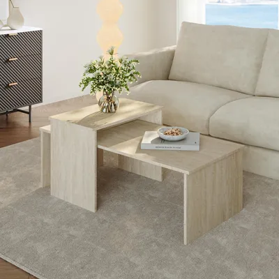 A living room scene with a sofa, a cabinet, and a nesting coffee table set.