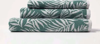 Produktbild von HOMESCAPES Frottee-Handtuch grün mit Blätter-Motiv - 50 x 85 cm, 100% Baumwolle