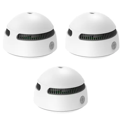 Three white smoke detectors are arranged in a diagonal pattern against a white background.