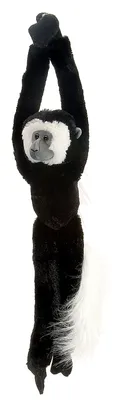 A plush toy monkey hanging by its arms against a white background.