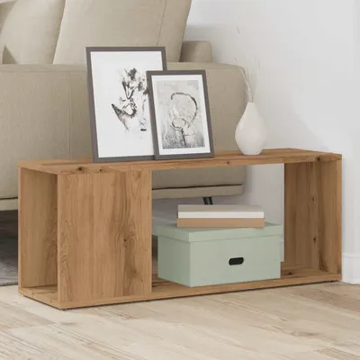 A wooden TV stand with decorative items and storage boxes.
