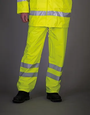 A person wearing high-visibility rain trousers and jacket.