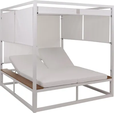 A white outdoor lounge bed with white cushions and a wooden shelf.