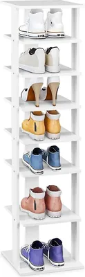 A vertical shot of a white, multi-tiered shoe rack with various pairs of shoes on each shelf.