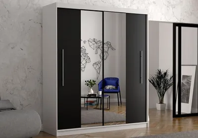 A modern bedroom with a large wardrobe featuring mirrored doors and black panels, reflecting a blue chair and a world map wall decal.