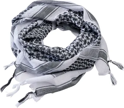 A folded black and white patterned scarf with tassels.