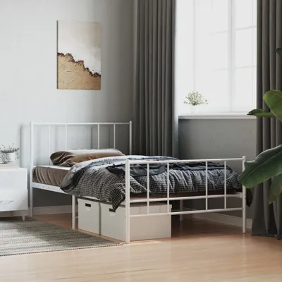A white metal bed frame with bedding and storage drawers underneath, set in a bedroom with curtains and a window.