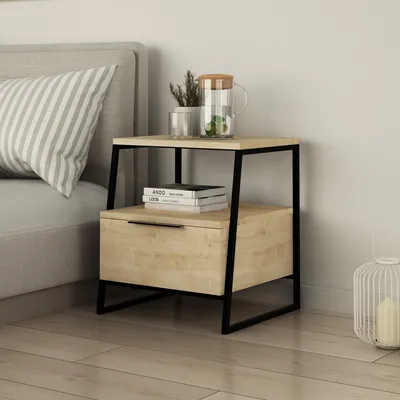 A bedside table next to a bed.
