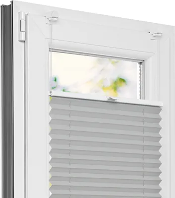 A close-up view of a light gray pleated blind installed on a white window frame.
