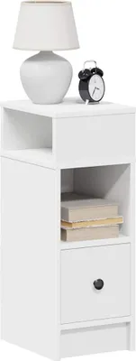 A white nightstand with a drawer and an open shelf, displayed against a white background. A lamp and an alarm clock are placed on top.