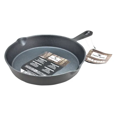 A cast iron frying pan with a tag attached to the handle.