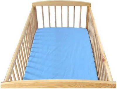 A baby crib with a blue fitted sheet.