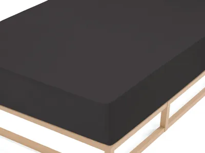 A close-up view of a dark gray fitted sheet on a wooden bed frame.