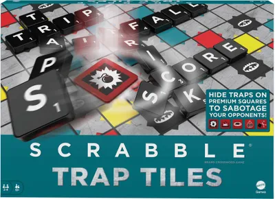 A close-up marketing image of the Scrabble Trap Tiles board game, showing game tiles on a game board with a bomb icon.