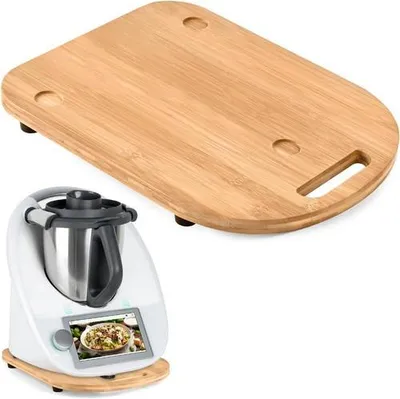 A wooden cutting board is placed above a kitchen appliance, likely a food processor, on a white background.