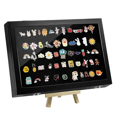 A display case filled with various enamel pins, shown on a wooden easel.