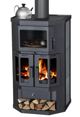 A black wood-burning stove with a glass door and a pizza inside, a kettle on top, and firewood below.