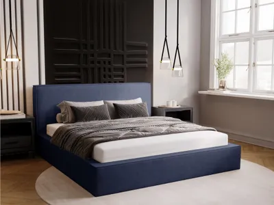 A bedroom scene with a blue upholstered bed.