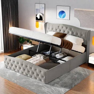 A bed with storage is open, showing contents.