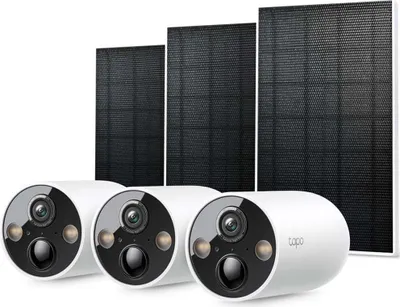 Three white security cameras and three solar panels are arranged in a studio setting against a white background.