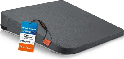 A gray wedge-shaped cushion with tags attached.