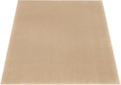 A square beige rug is shown from a slightly elevated angle against a white background.