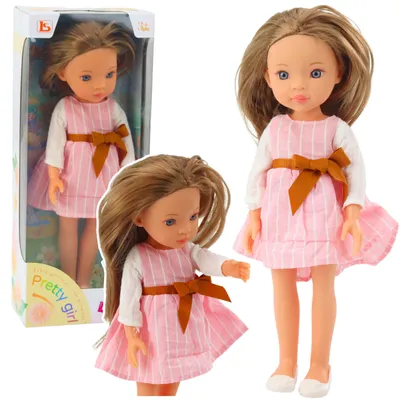Image de Poupée en robe rose avec un nœud, cheveux longs et bruns