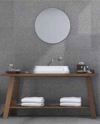 A modern bathroom vanity with a sink, mirror, and towels.