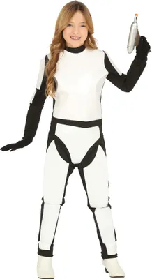 A young girl wearing a white and black costume, holding a silver toy blaster.