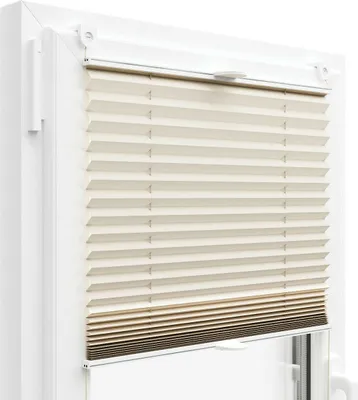 A close-up view of a pleated blind installed in a window frame.