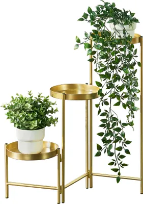 A gold plant stand with two potted plants against a white background.
