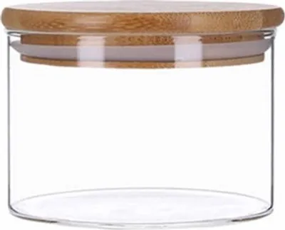 A clear, studio shot of a glass storage jar with a bamboo lid.