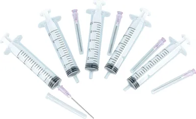 Multiple syringes and needles are arranged on a white background.