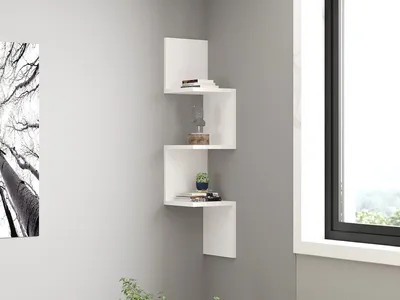 A white corner shelf unit is mounted on a light gray wall next to a window.
