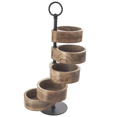 A multi-tiered serving stand with wooden bowls.