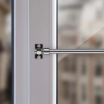 Close-up of a window curtain rod bracket and rod.