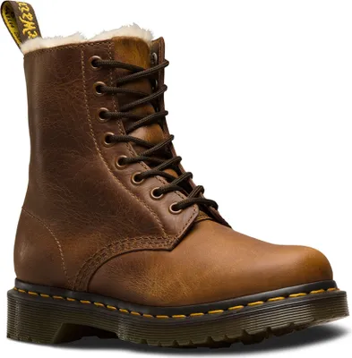 A single brown Dr. Martens boot with fur lining.
