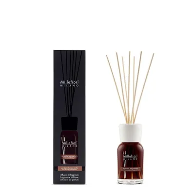 A product shot of a fragrance diffuser and its packaging against a white background.