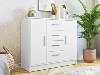 A white dresser with four drawers and two doors is shown in a room with patterned wallpaper and a potted plant.