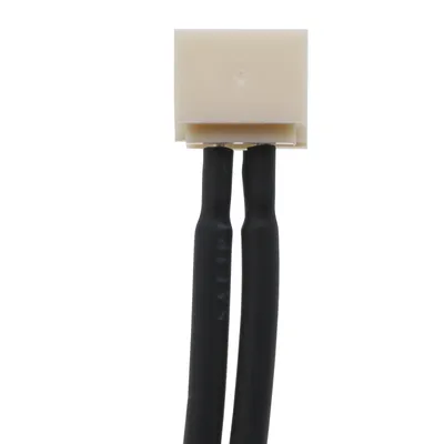 A close-up view of a beige connector with two black wires extending downwards.