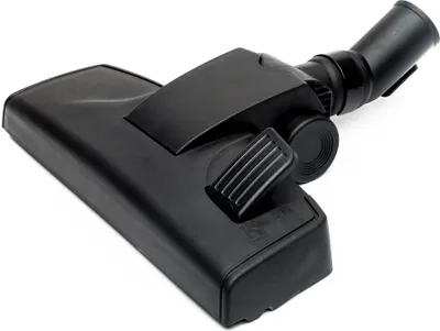 A black vacuum cleaner floor nozzle is shown from a slightly elevated angle against a white background.