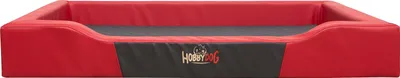 A red dog bed with a black panel on the front.