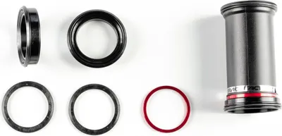 A collection of bicycle bottom bracket components laid out on a white background.