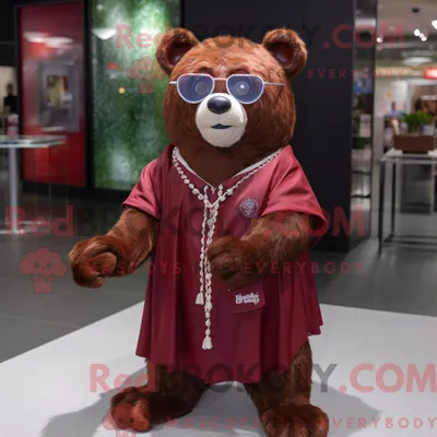 Produktbild von Maskottchenfigur REDBROKOLY eines kastanienbraunen Bären mit Maxikleid und Brille