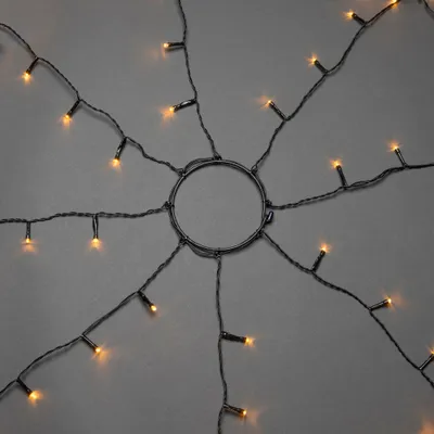 Produktbild von Konstsmide - LED Baummantel mit Ring, 8 Stränge à 30 Dioden, vormontiert, mit Glimmereffekt, 240 bernsteinfarbene Dioden (120 glimmend), 24V Außentrafo, schwarzes Kabel - 6320-810