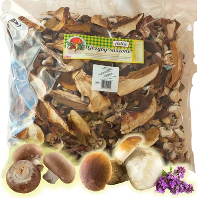 A bag of dried mixed mushrooms with some fresh mushrooms and herbs at the bottom.